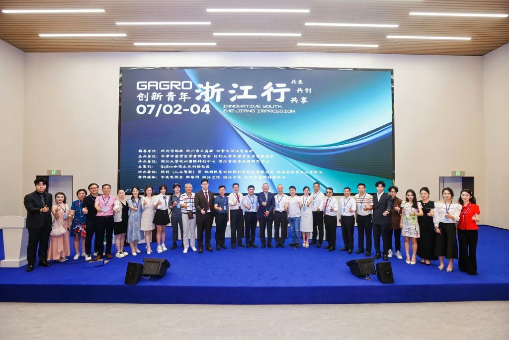 Formal group photo of the GaGro global network at a conference stage
